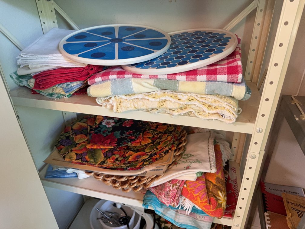 Contents of Two Shelves with 2 Vintage Lazy Susans and Linens