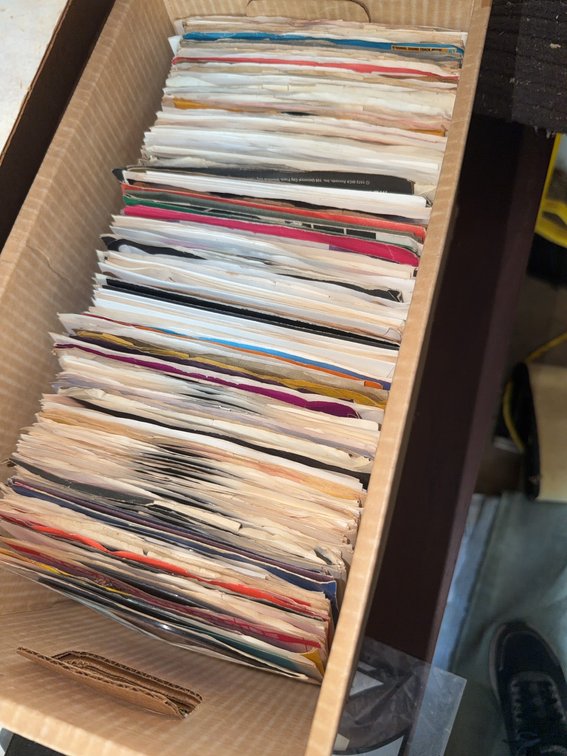 Over 50 Assorted 45 RPM Records With Sleeves and Labels