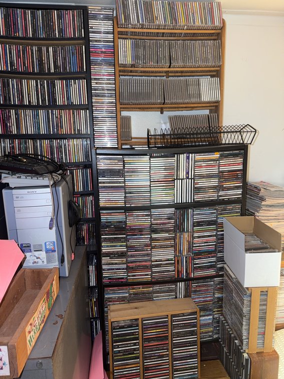 Over 1,000 Assorted Music CDs With Storage Racks and Boxes