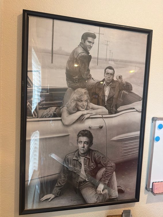 Framed Black and White Poster Featuring Classic Movie Icons in Car Scene