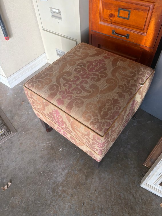 Upholstered Footstool With Patterned Fabric And Wooden Legs