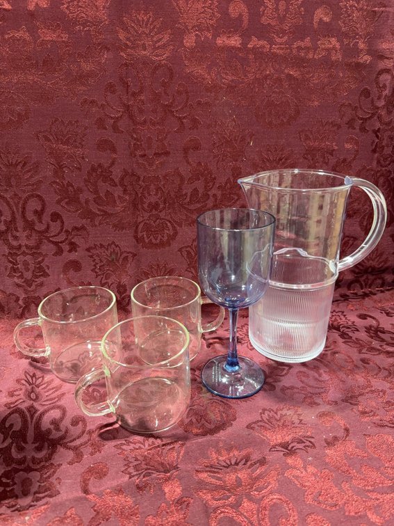 Plastic Pitcher, Blue Plastic Wine Glass, and Three Clear glass Coffee Cups Assortment