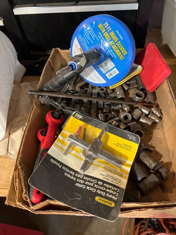 Tools Including Drain Cleaner, Sockets, and Circle Cutter