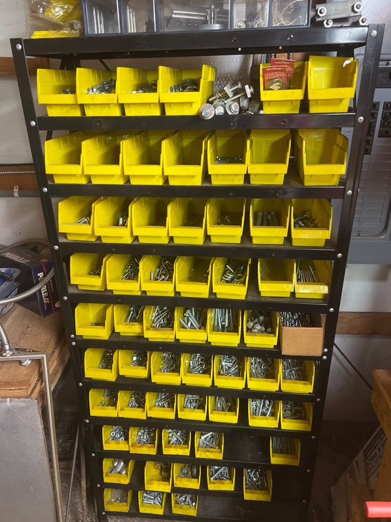 Metal Storage Rack With Yellow Bins and Hardware Assortment