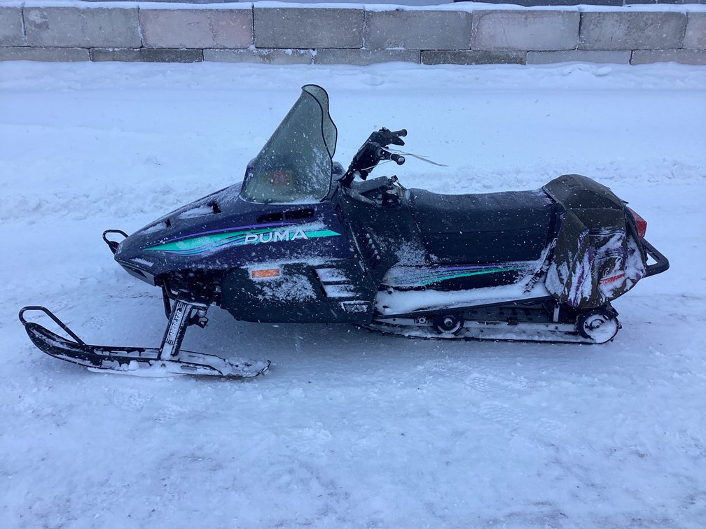 1994 Arctic Cat 340 Puma snowmobile, started, shows 4,512 miles, registration.