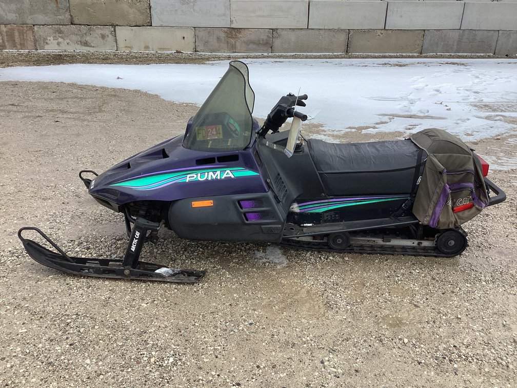 1994 Arctic Cat Puma snowmobile, started, shows 4,512 miles, registration.