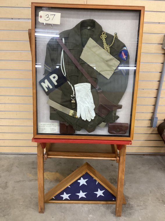 Post WWII Military Police Uniform framed on stand.