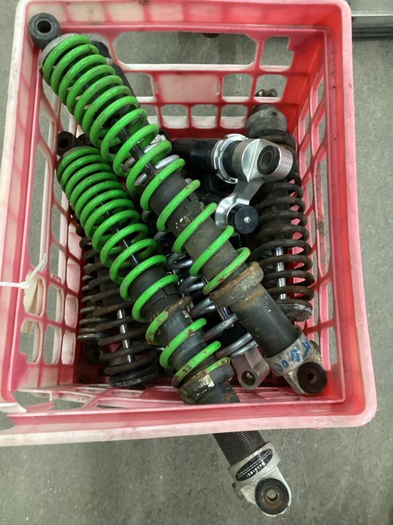 Crate of snowmobile shocks.