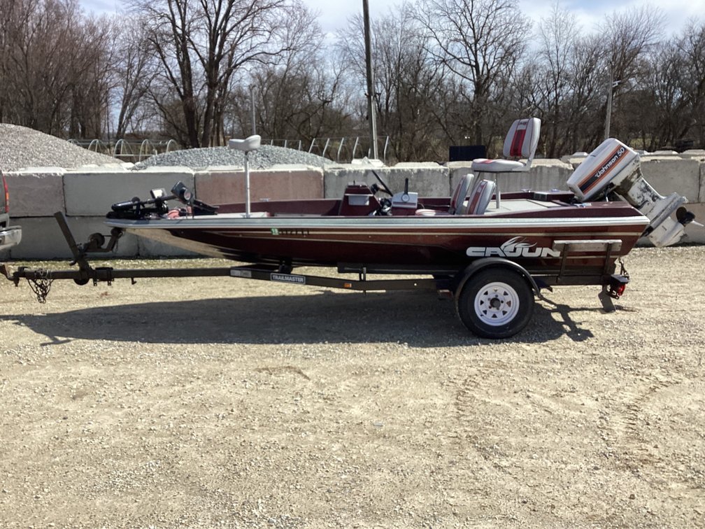 1989 Cajun Cutlass 16’ boat w/ 50HP outboard (started) & 1989 Trailmaster trailer