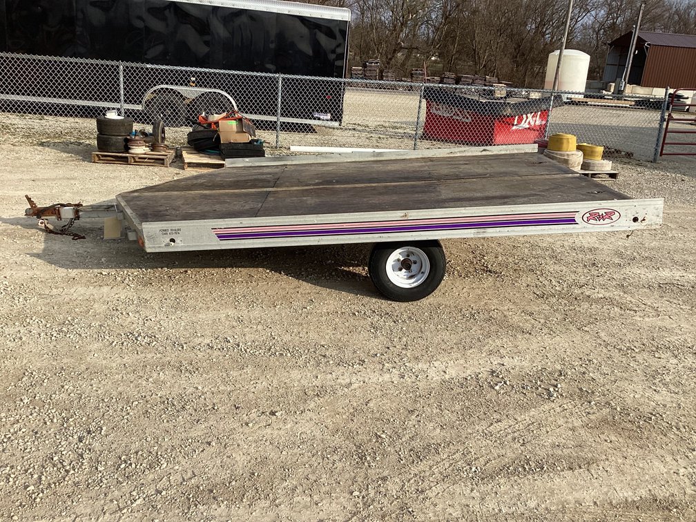 1984 R&R 10’ snowmobile trailer w/ rear ramp. Registration. 