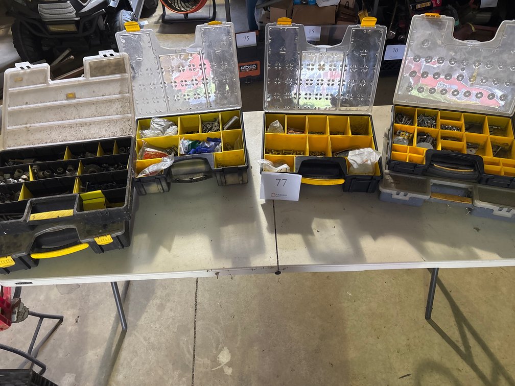 YELLOW AND BLACK CONTAINERS WITH VARIOUS NUTS, BOLTS AND SCREWS