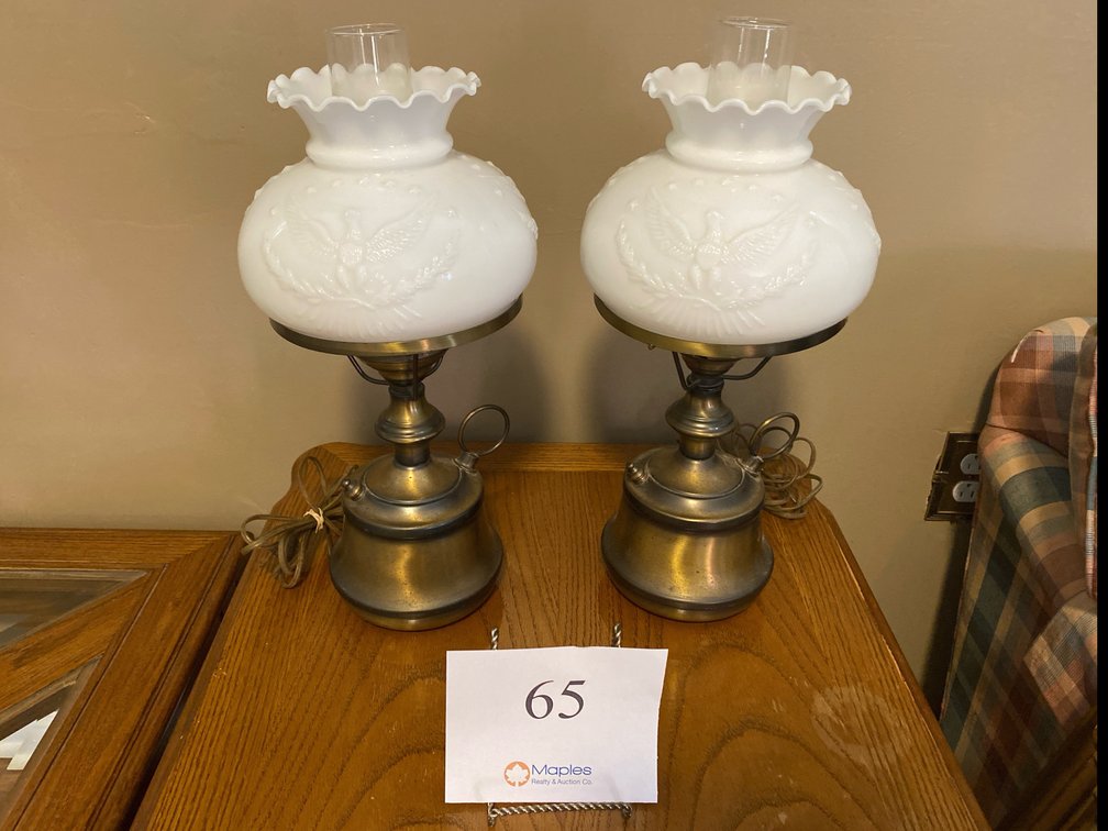TWO BRASS LAMPS WITH SCALLOPED MILK SHADES EMBOSSED WITH AN EAGLE AND STAR DESIGN