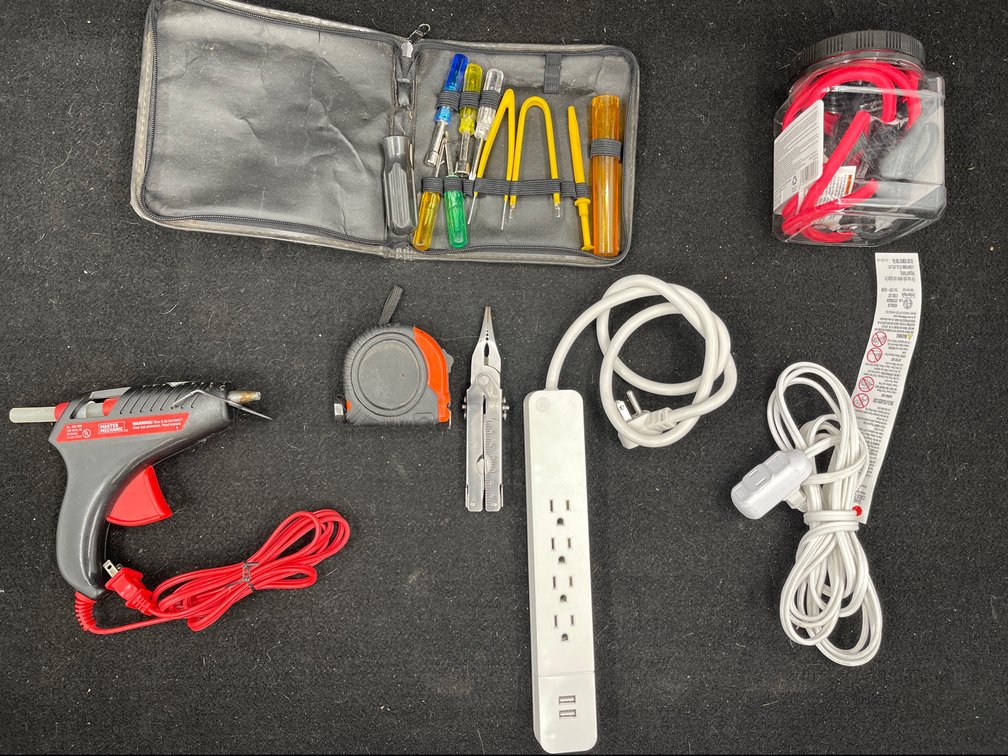 Glue Gun, Small Tool Kit, Bungie Cords, Extension Cord, Surge Protector, Tape Measure, Multi Tool