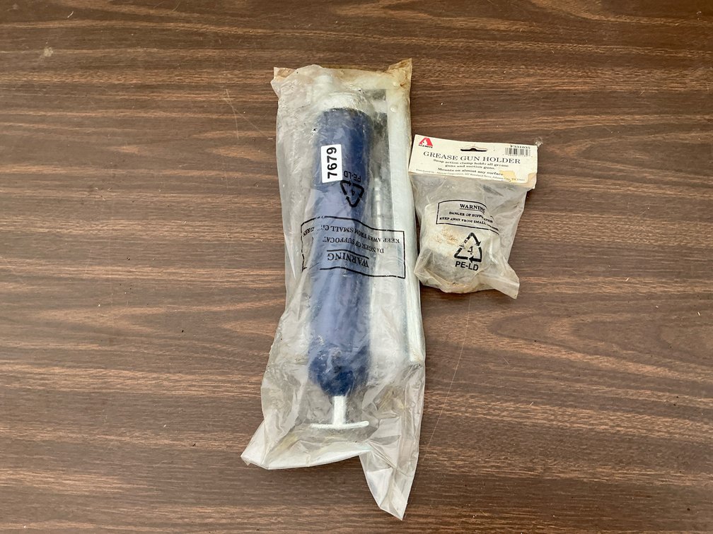 Lincoln grease gun and holder