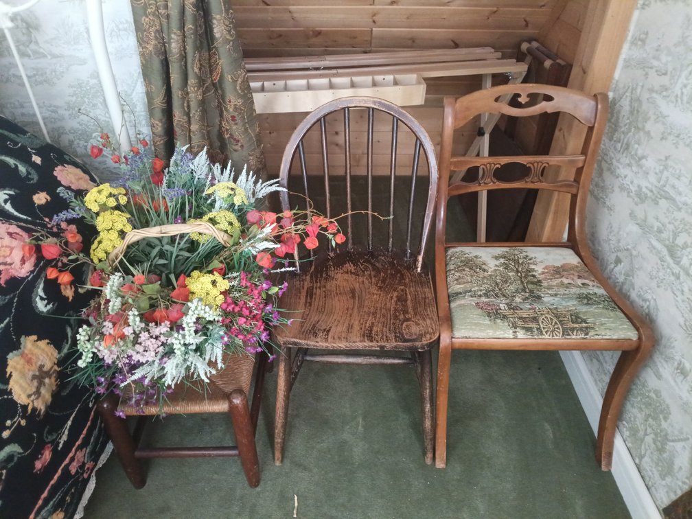 Vintage & Antique Wooden Chair Lot with Wicker Stool, Basket & Floral Arrangement