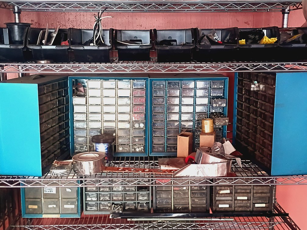 Three Shelves Of Hardware Organizers Full Of Hardware