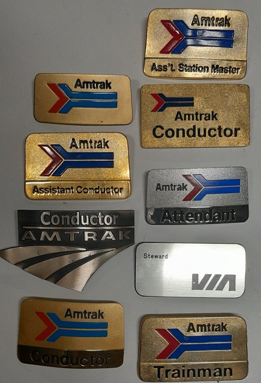 9 Hat badges Amtrak & 1 Via - Various age Angier Collection