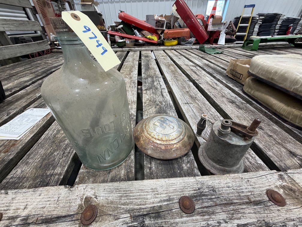 Old IH hubcap, old blowtorch, and old IH  glass oil dispensing bottle