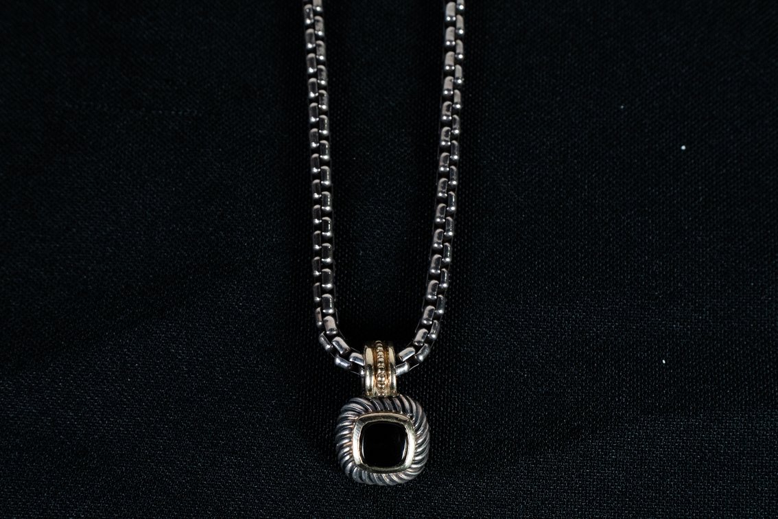David Yurman petite pendant necklace neck lace featuring a black onyx gemstone set in sterling silver, with a twisted gold accent around the top of the pendant. 