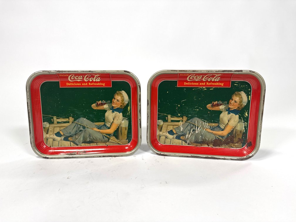 Lot of two 1940 Coca-Cola sailor girl metal serving trays.