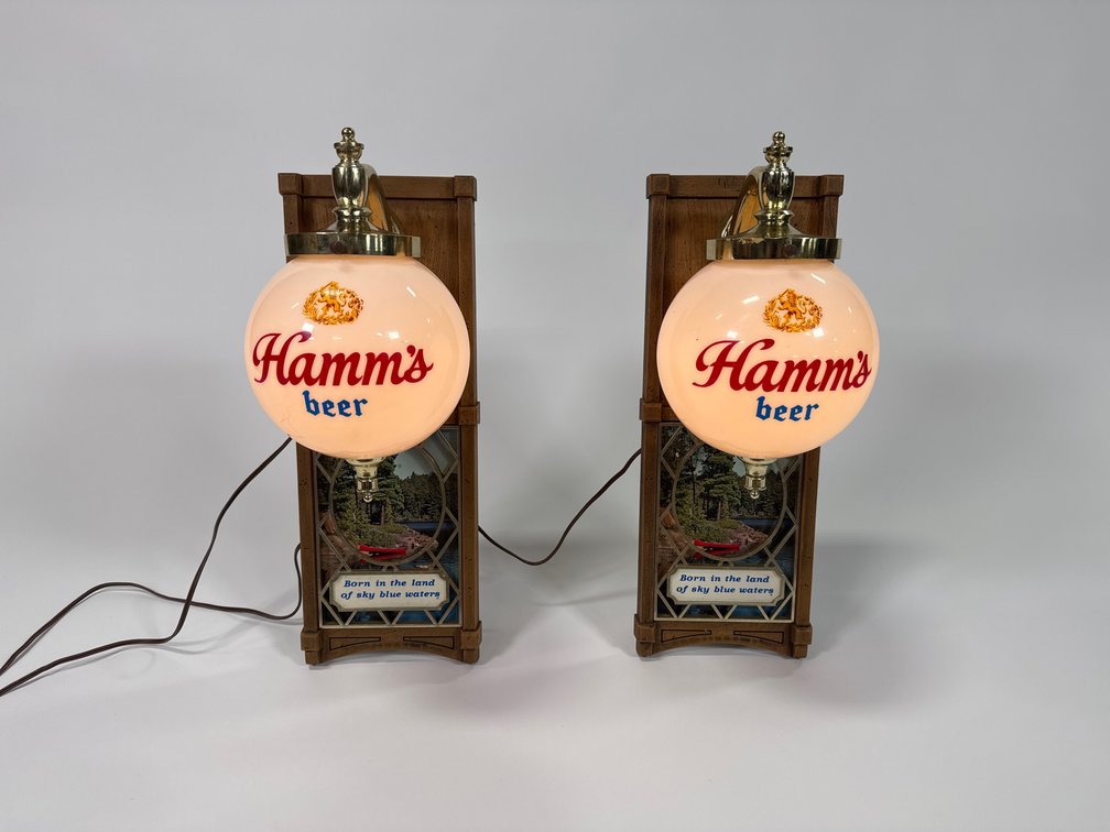 Pair of circa 1960s Hamm’s Beer lighted globe wall sconces.