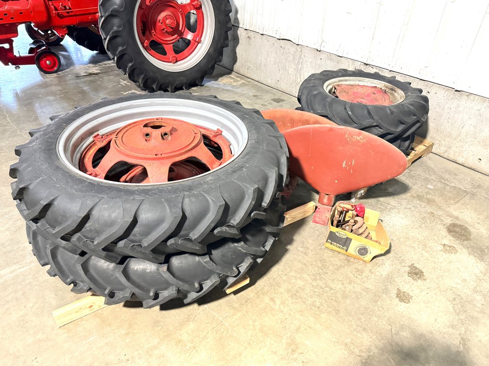 Lot of tractor wheels and fenders with mounting parts 