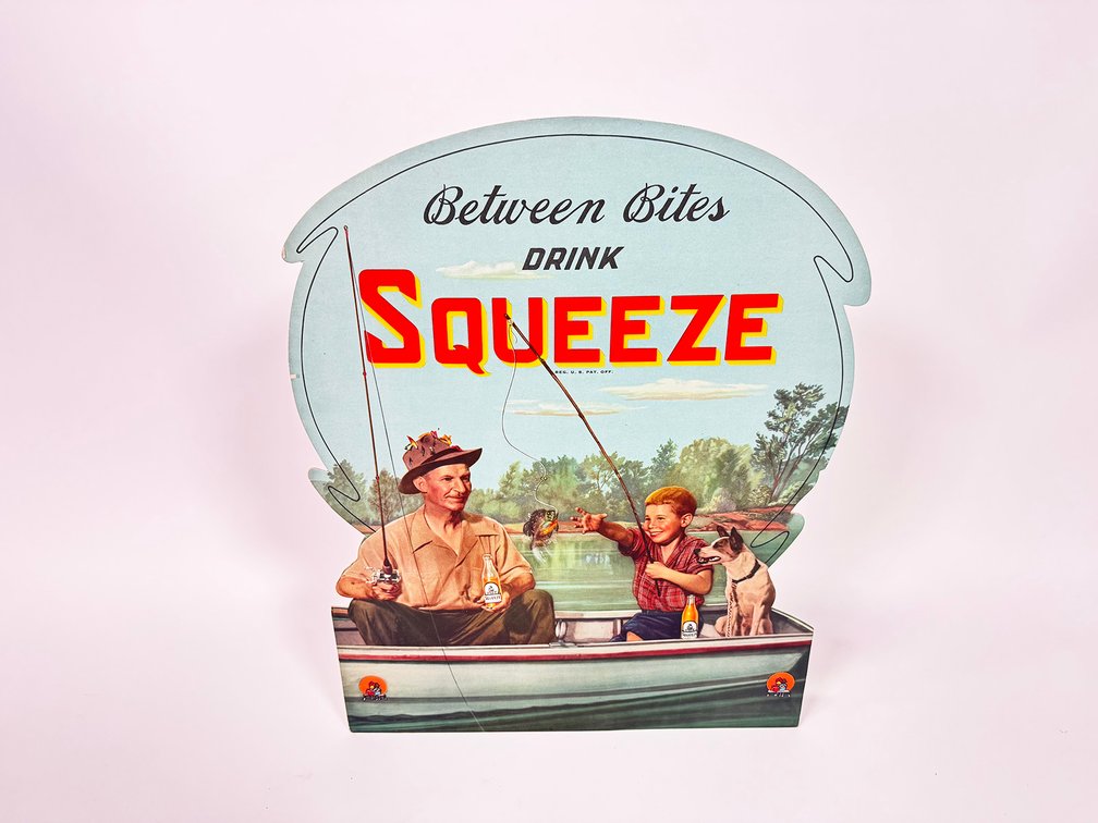 NOS late 1940s Squeeze Orange Soda single-sided die-cut cardboard easel-backed sign. 