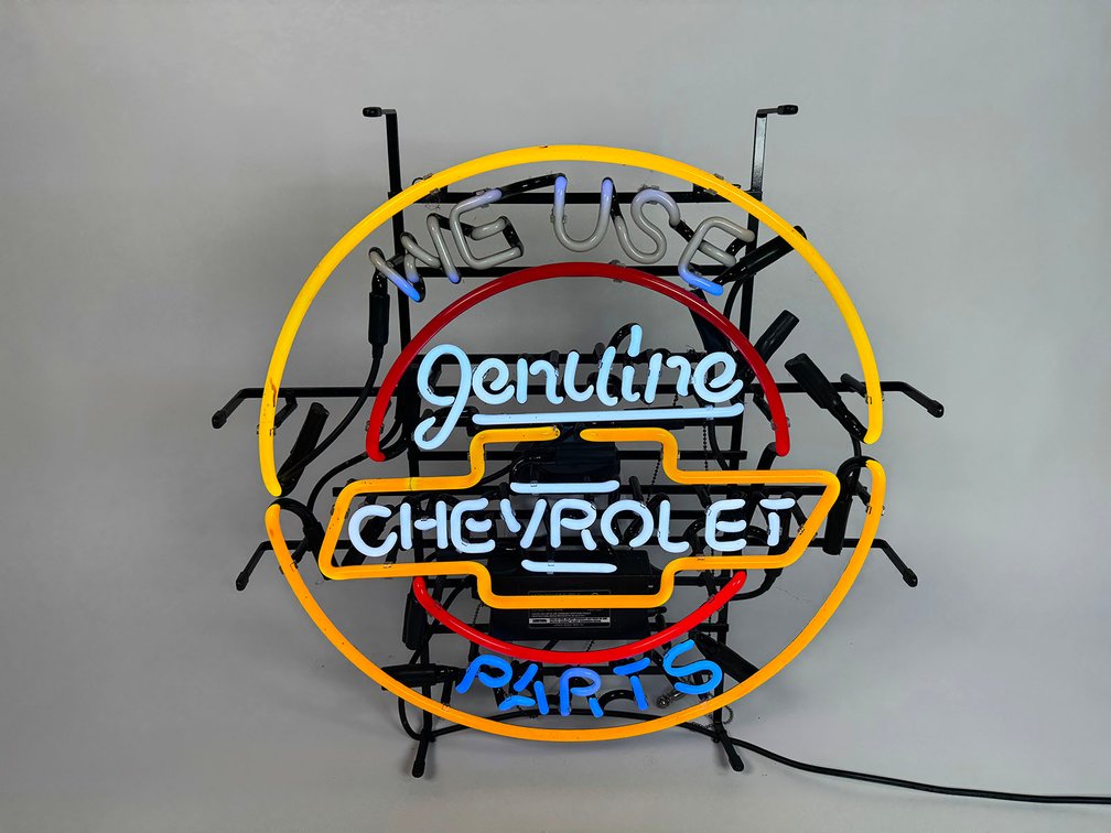 Newer We Used Chevrolet Genuine Parts neon dealership sign.