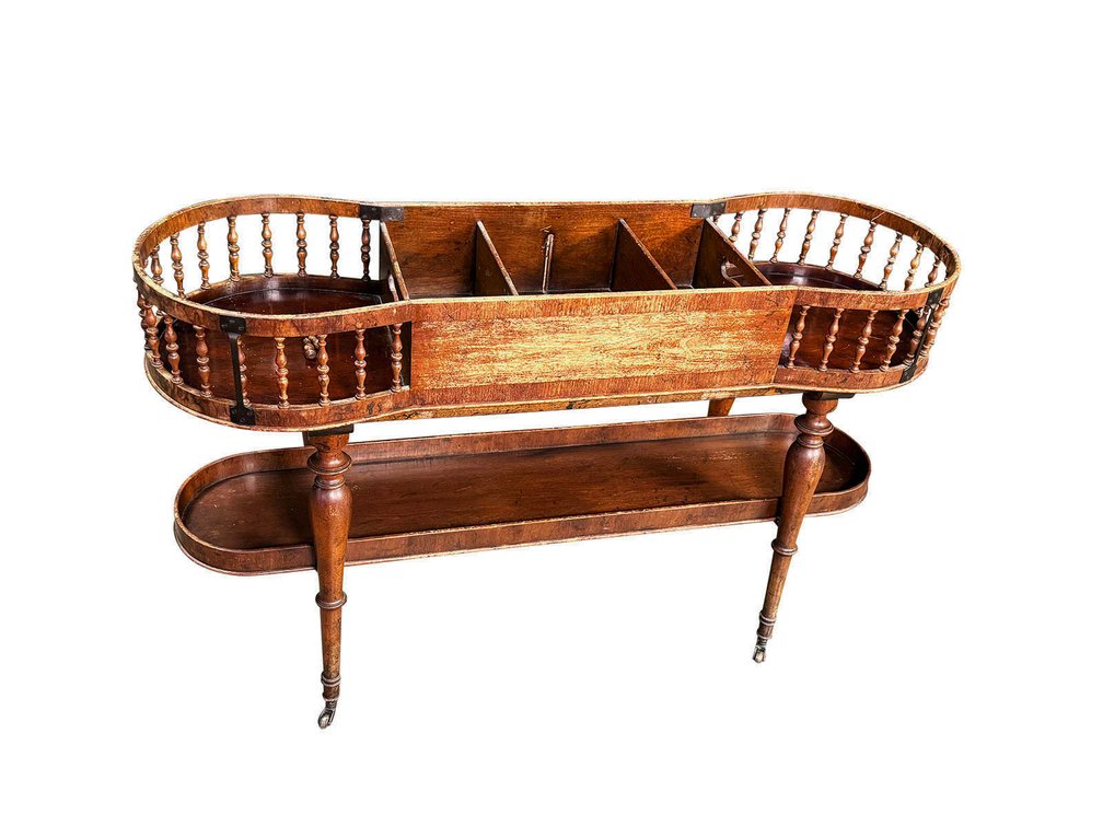 George III mahogany double plate and cutlery stand on casters.
