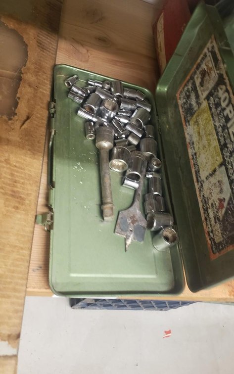 tools in green tin box