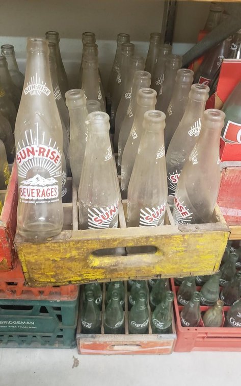 Sunrise Beverage bottles in yellow case