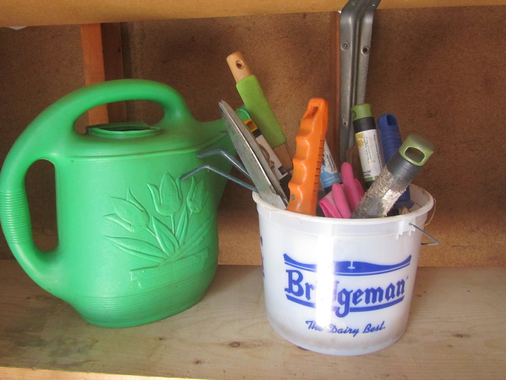 Bucket Of Gardening Tools And Plastic Watering Can