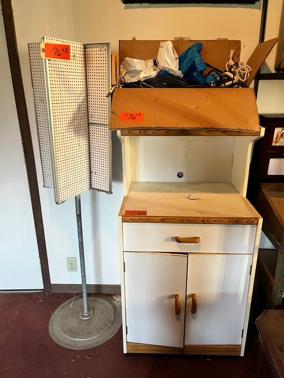 Wood Cabinet With Rotating Display And Assorted Cords