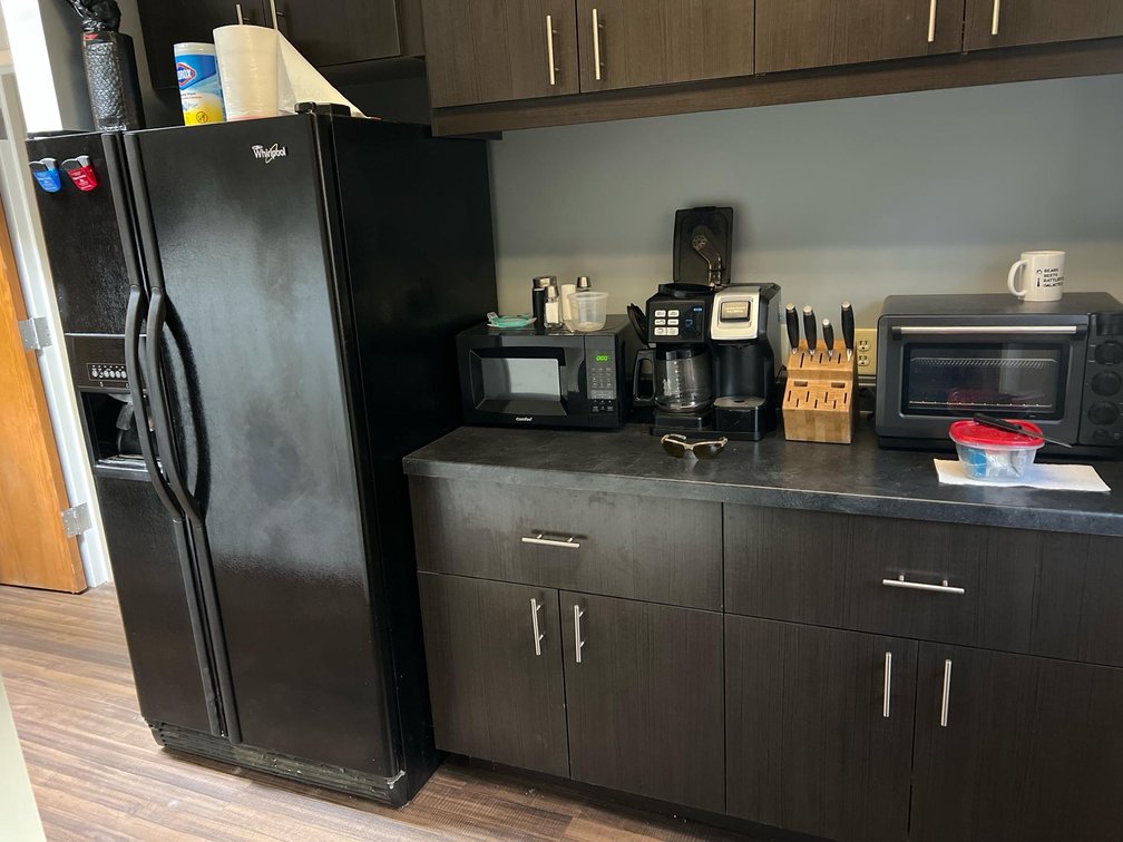 All Appliances in this kitchenette including Whirlpool Side-by-Side Refrigerator