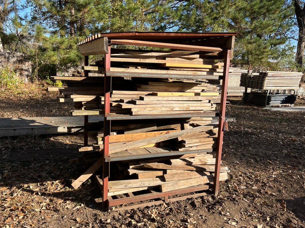 Covered Shelf of Assorted 2x4 Lumber and Stakes