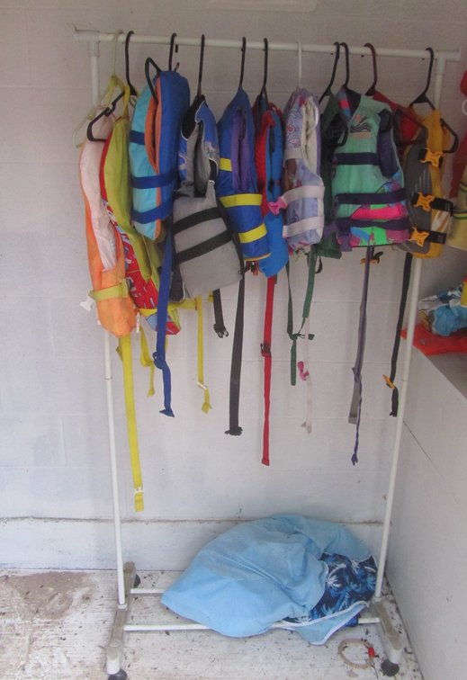 Clothing Rack w/Assorted Youth Life Jackets And Inflatables
