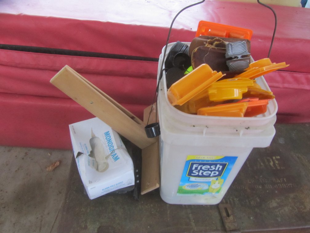Bucket Full Of Gun Cleaning Supplies, Knife Sharpeners, And More