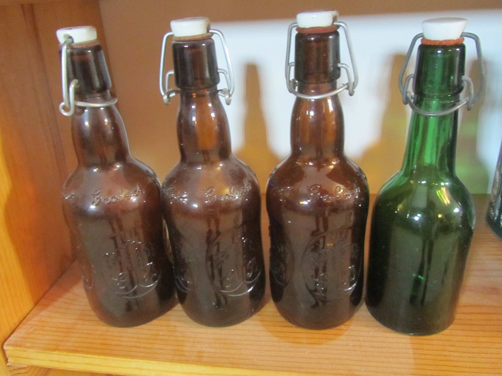 (3) Vintage Brown Glass Grolsch Bottles And (1) Vintage Green Glass Bottle