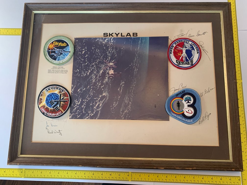 Patches From Skylab Missions and A Picture of Skylab In Space. Signed By The Mission Astronauts. Signatures Have Not Been Authenticated. In A 26”x19” Frame