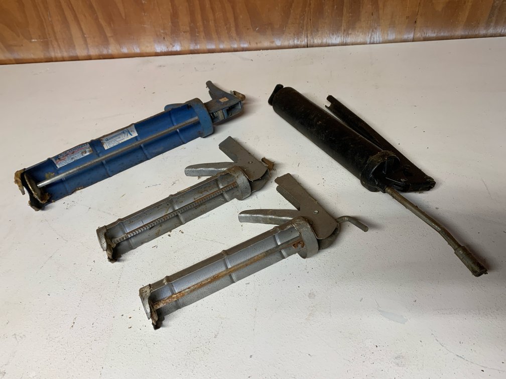 3 Caulk Guns and A Grease Gun