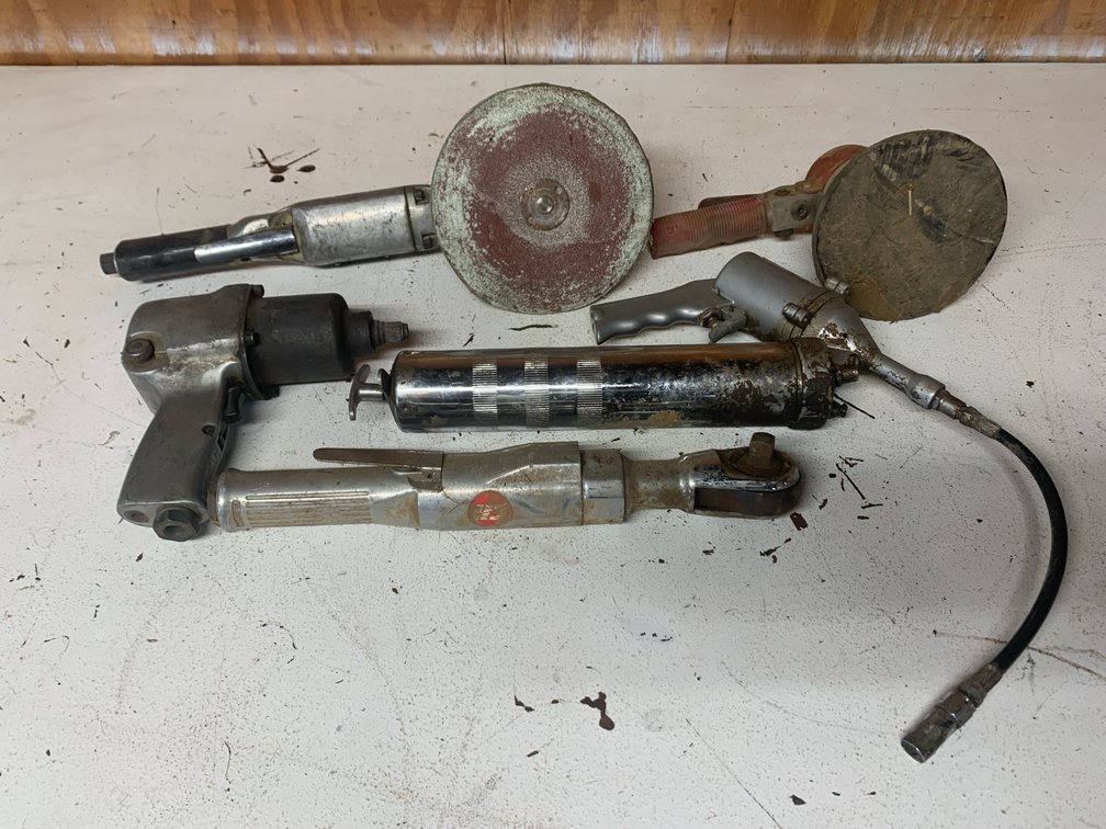 Five Pneumatic Hand Tools. One Grease Gun, Two Sanders, and Two Ratchets