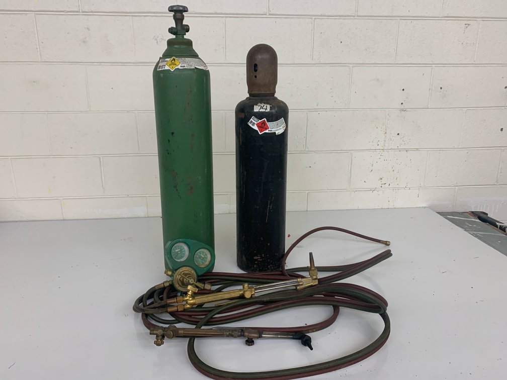 Acetylene Torch Kit. Includes 35” Tall Oxygen Tank, 31” Tall Acetylene Tank, Hose, Gauge, and Two Torch Tips