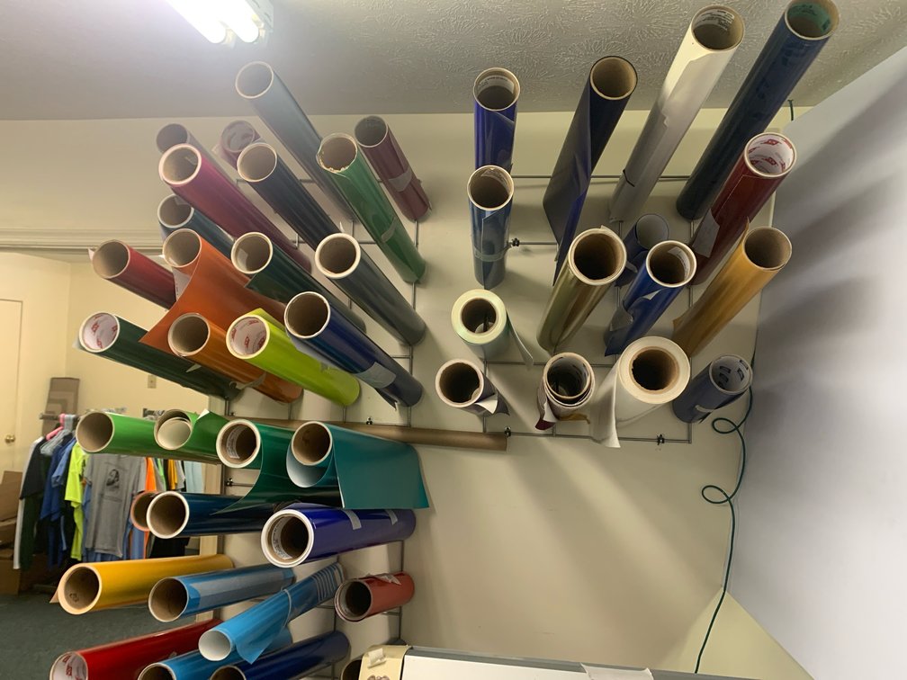 Three Racks Of Assorted Rolls Of Vinyl For A Plotter. 15” and 24”. Racks Are Included