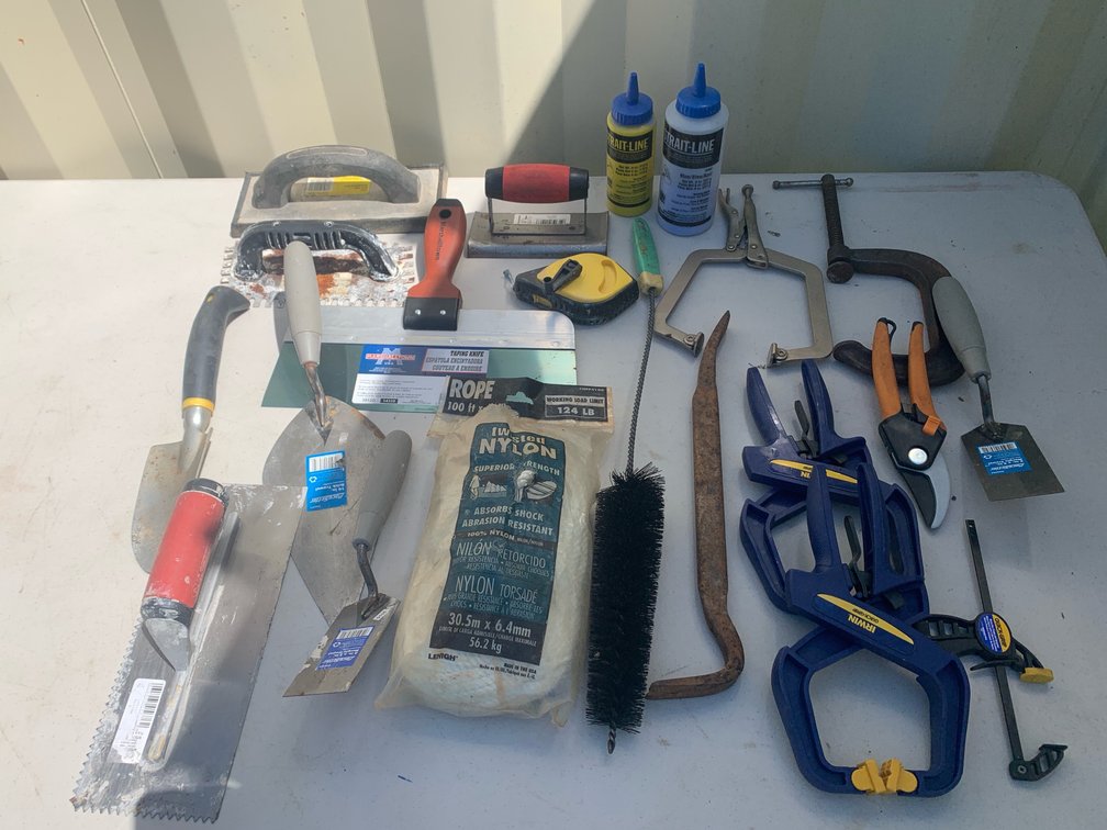 Box Of Assorted Trowels And Clamps, A Rope, And A Chalk Box
