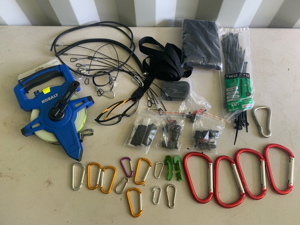 Assortment Of Carabiners, Straps, Small Cables, and A Kobalt 100’ Tape Measure