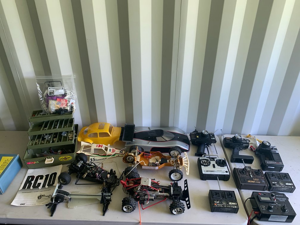 Assortment Of RC Cars, Remotes, and Parts