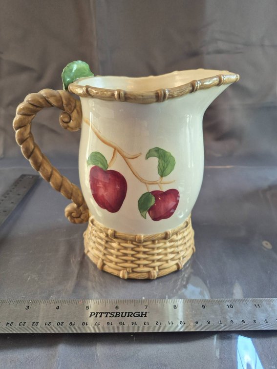 Two Ceramic Pitchers with Apple Motifs and Woven Handle Detail