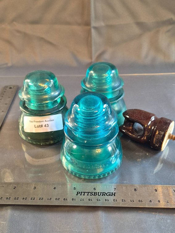 Three Hemingray-42 Aqua Glass Insulators with One Porcelain Insulator
