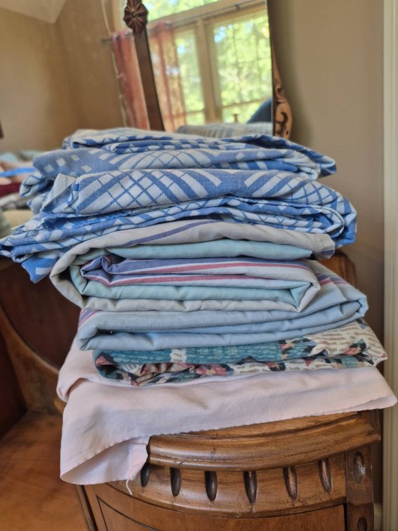 Various Bedding Items Including Sheets and Covers