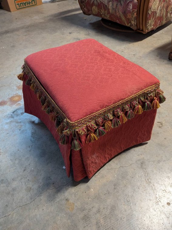 Red Upholstered Ottoman With Tassel Detailing